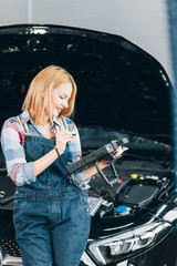 happy girl controlling the condition of a vehicle. close up photo. modern technology and gadget