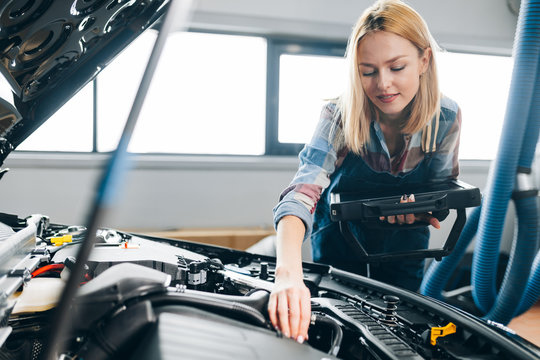 awesome mechanic determining system error at the garage. close up photo. copy space - Powered by Adobe