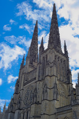 Fototapeta na wymiar Cathedral of Saint-André overhanged by a dramatic blue sky, place Pey-Berland, Bordeaux, France