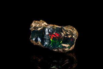 Macro stone Opal mineral in rock on a black background close up