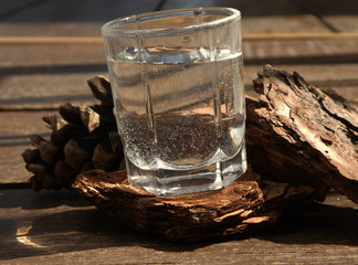  a glass of water on a brown wood background