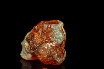 Macro stone Opal mineral in rock on a black background close up