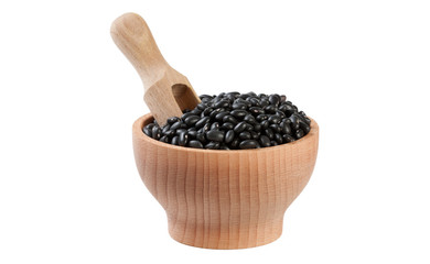 black bean in wooden bowl and scoop isolated on white background. nutrition. food ingredient.