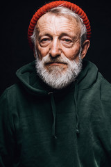 Face portrait of gloomy experienced grey-haired old-aged man with skin lined with wrinkles, dressed...