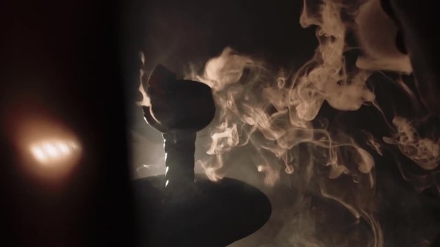 thick white smoke from a hookah on a black background