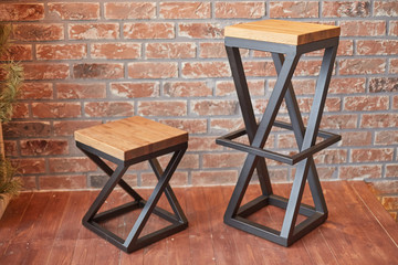 two stylish chairs on a brick wall background