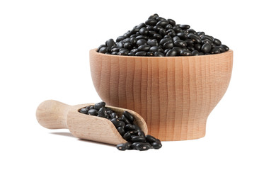 black bean in wooden bowl and scoop isolated on white background. nutrition. food ingredient.