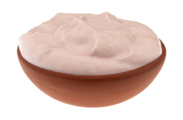 Small bowl of red raspberry yogurt on a white background side view