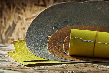 abrasives round square and rolled  sheets of sandpaper on plywoo