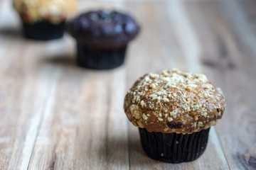 Assorted muffin on wooden background.