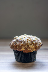 Banana muffin on wooden background.