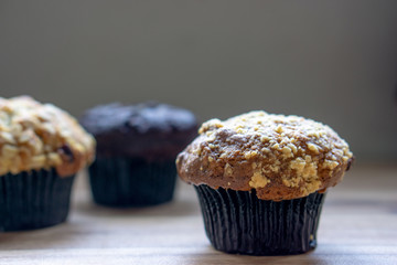 Assorted muffin on wooden background.