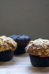 Assorted muffin on wooden background.