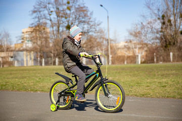 little boy riding runbike, early sport. child learns to ride a bike