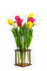 bouquet of tulips in the original wooden vase. Isolated on white background.