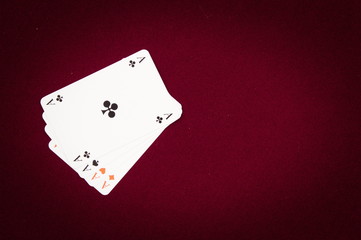 Four aces isolated on red
