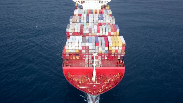 Ultra large container vessel (ULCV 366 Meters long) loaded with various Container brands, at sea - Aerial footage.