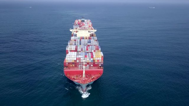 Ultra large container vessel (ULCV 366 Meters long) loaded with various Container brands, at sea - Aerial footage.
