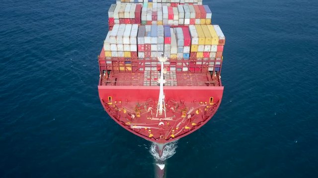 Ultra large container vessel (ULCV 366 Meters long) loaded with various Container brands, at sea - Aerial footage.