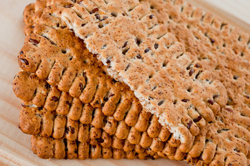 Dieting cookies with flax seeds and sunflower seeds and cracknels on the background
