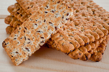 Dieting cookies with flax seeds and sunflower seeds and cracknels on the background
