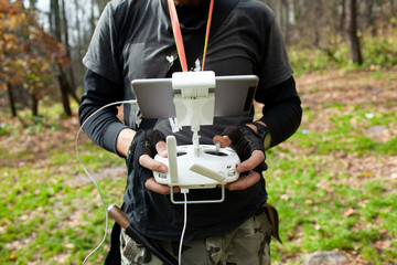 Male tourist exploring new places. Handsome bearded man on nature with fuel. Using drone...