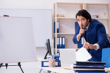 Young handsome businessman working in the office