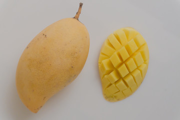 Yellow mango fruit on a white background