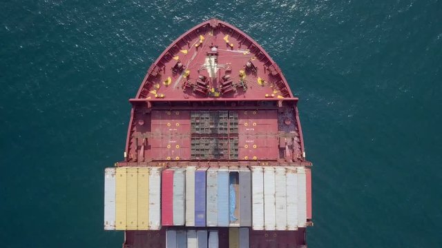 Ultra large container vessel (ULCV 366 Meters long) loaded with various Container brands, at sea - Aerial footage.