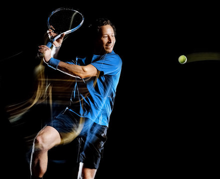 one caucasian tennis player man isolated black background in light painting speed motion