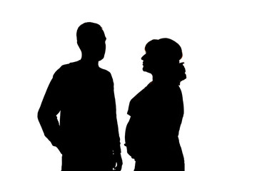 A pregnant woman and a man. Black silhouettes on white background. In isolation
