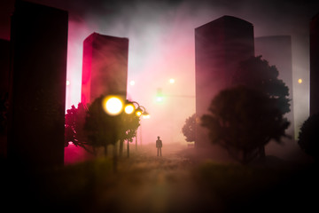 Artwork decoration. A man standing on a road of burnt up city. Apocalyptic view of city downtown as...