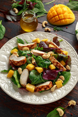 Grilled Chicken Mango salad with nuts and vegetables. Healthy food.