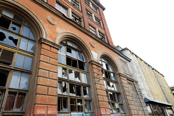 Facade of an abandoned industrial enterprise. Large Windows with broken glass. abandoned plant 