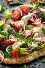 Roasted Duck kebab on flat bread with yogurt dip and salad