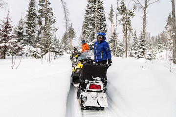 Athletes on a snowmobiles.