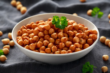 Roasted spicy chickpeas in white bowl. Healthy food
