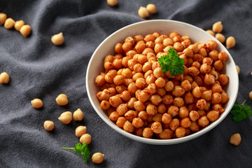 Roasted spicy chickpeas in white bowl. Healthy food