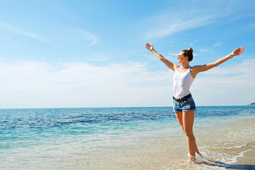 Portrait of young beautiful woman in tropical destination island beach with the ocean background. Joy of summer holidays concept. Close up, copy space