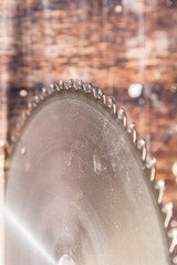 Close-up blade circular saw on the background of the wooden table Verscak. Workshop for the production of wooden products. Joiner's cutting tool