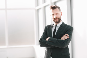Fototapeta premium successful businessman standing in a bright office
