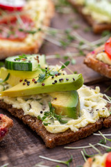 Sandwiches with cream cheese, vegetables and salami.