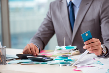 Young handsome businessman in budget planning concept 