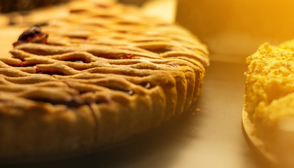 Glass show-window in coffee shop with pieces of tasty fruit pie. Tasty sweets