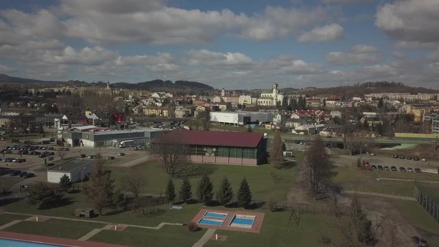 Gorlice, Poland - 3 9 2019: Panorama of the historic center of the European medieval city on the picturesque green hills. Trips to architectural monuments, temples, quarters and sports complex MOSiR
