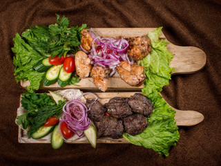 Grilled meat on a wooden Board with vegetables