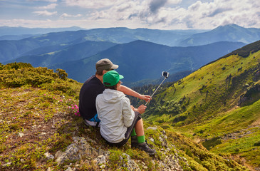 Young couple hiking taking selfie with smart phone.