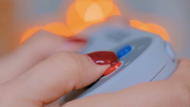 Close up shot of woman gamer hand playing video games with joystick or gamepad at home. Gaming, hobby, addiction, video game and leisure time concept