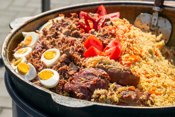 Pilaf cooked in a cauldron on the street. Close-up