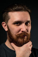 Fototapeta premium Portrait of a bearded man on a black background.